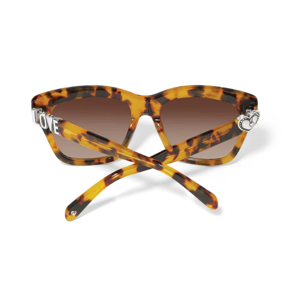 Tortoiseshell sunglasses with brown lenses on a white background