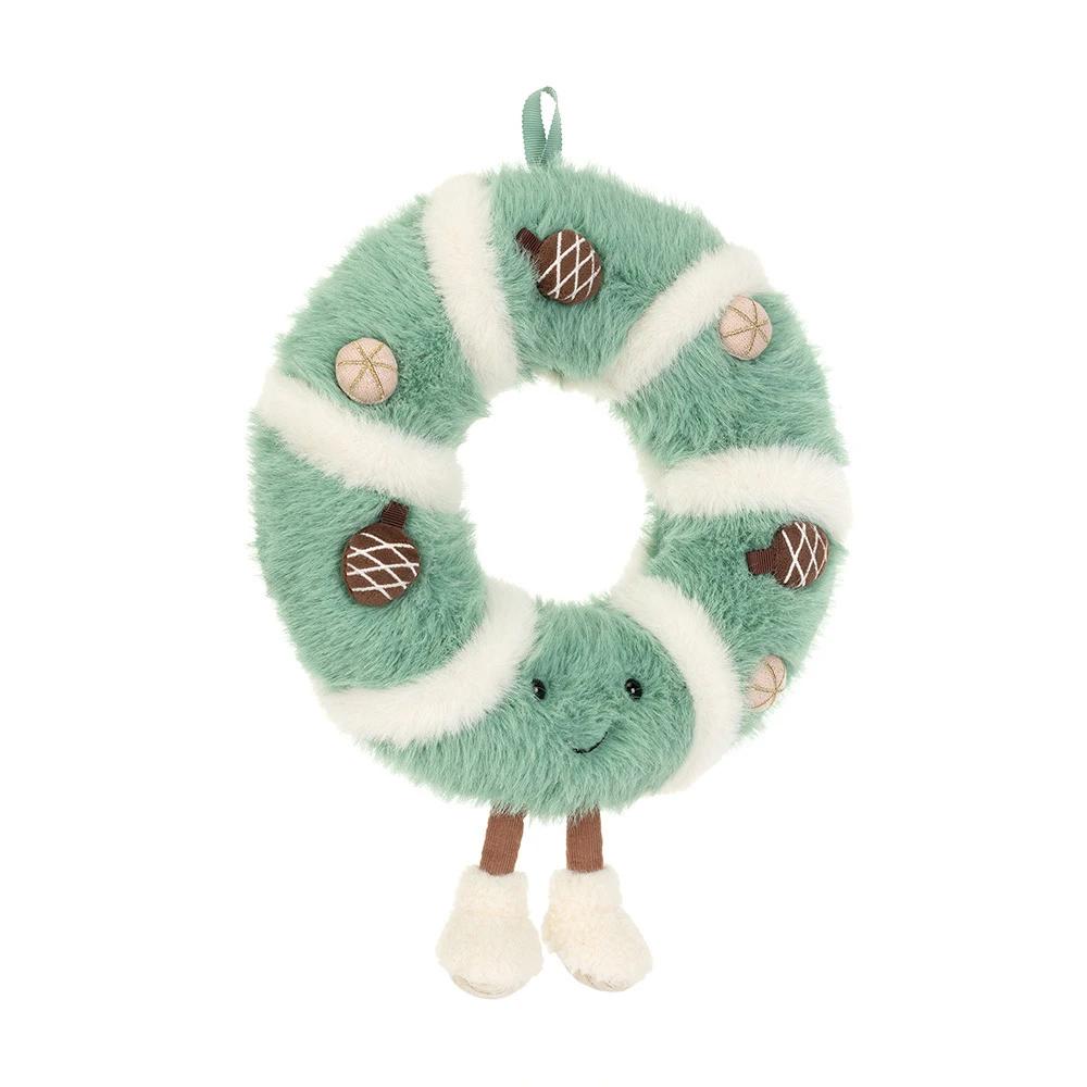 A green and white striped wreath-shaped plush toy with acorn and pinecone details, a hanging loop, and small legs with white feet, shown on a plain white background.
