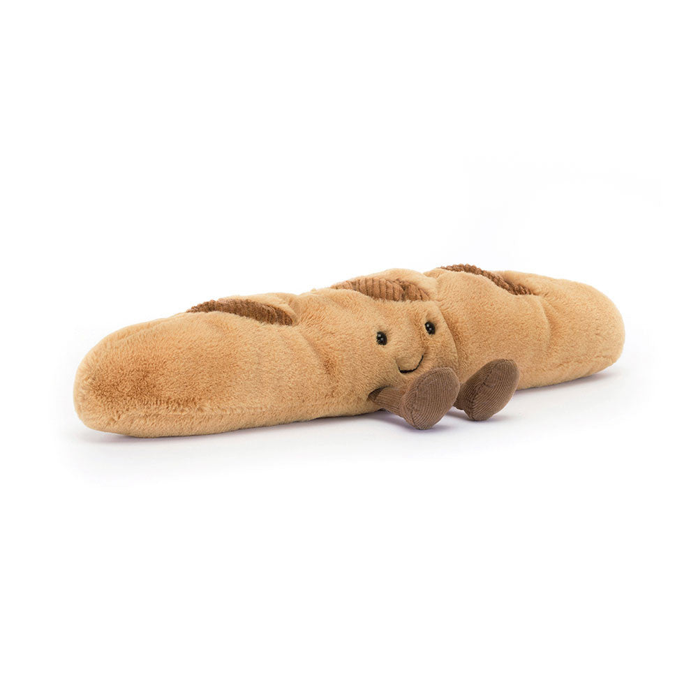 A angled photo of a  brown baguette plush toy with a face on a white background