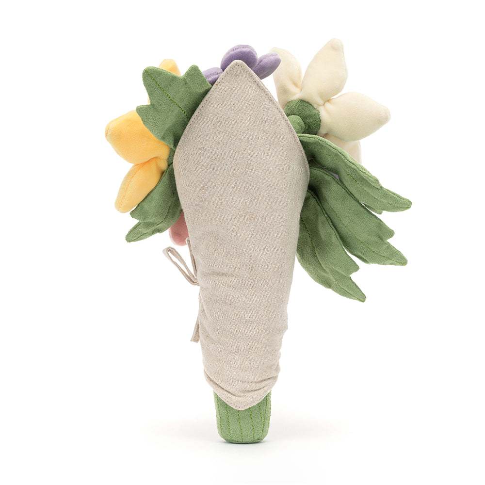 A plush toy bouquet of flowers with a variety of colors including pink, purple, and yellow, with a smiling face at the center, wrapped in beige fabric. Back side of item.

