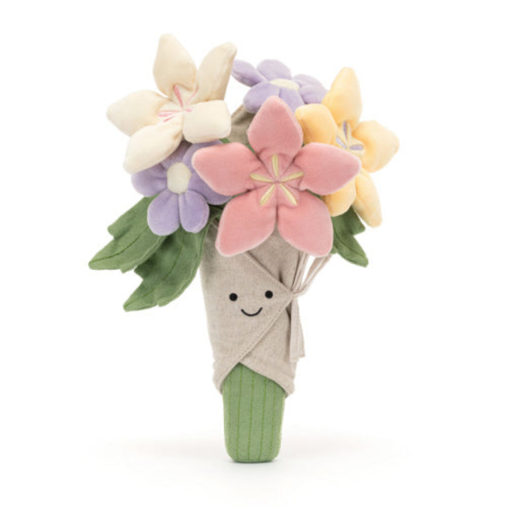 A plush toy bouquet of flowers with a variety of colors including pink, purple, and yellow, with a smiling face at the center, wrapped in beige fabric.