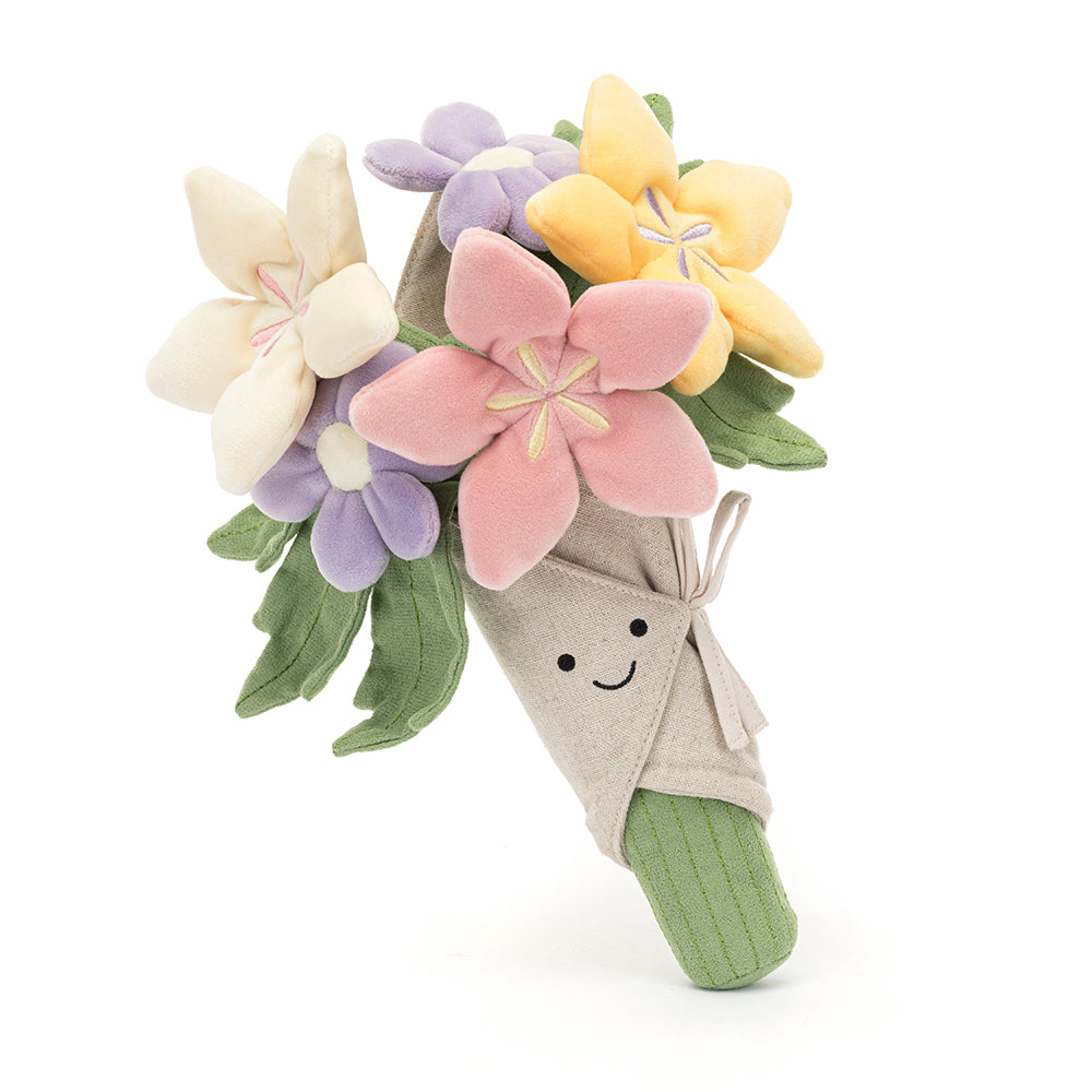 A plush toy bouquet of flowers with a variety of colors including pink, purple, and yellow, with a smiling face at the center, wrapped in beige fabric. Side of item.