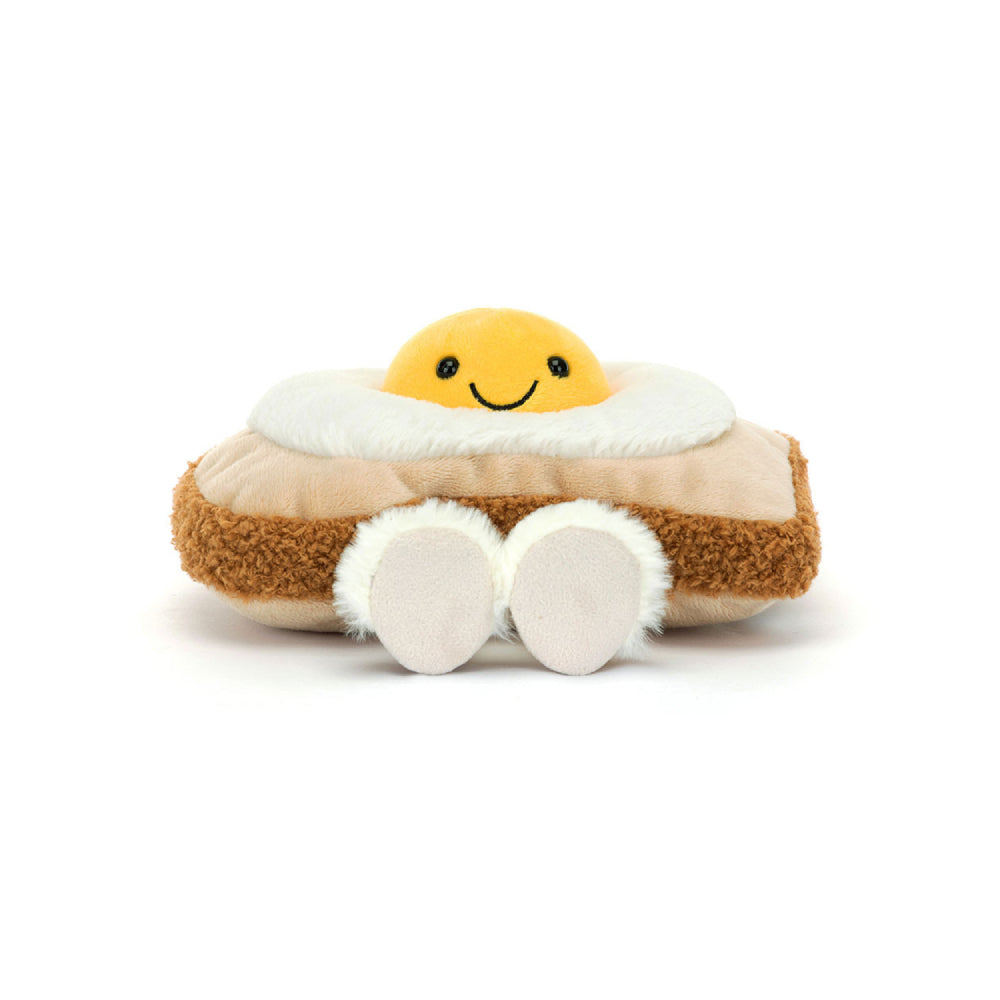 Plush toy resembling a egg on toast with a smiley face on a white background