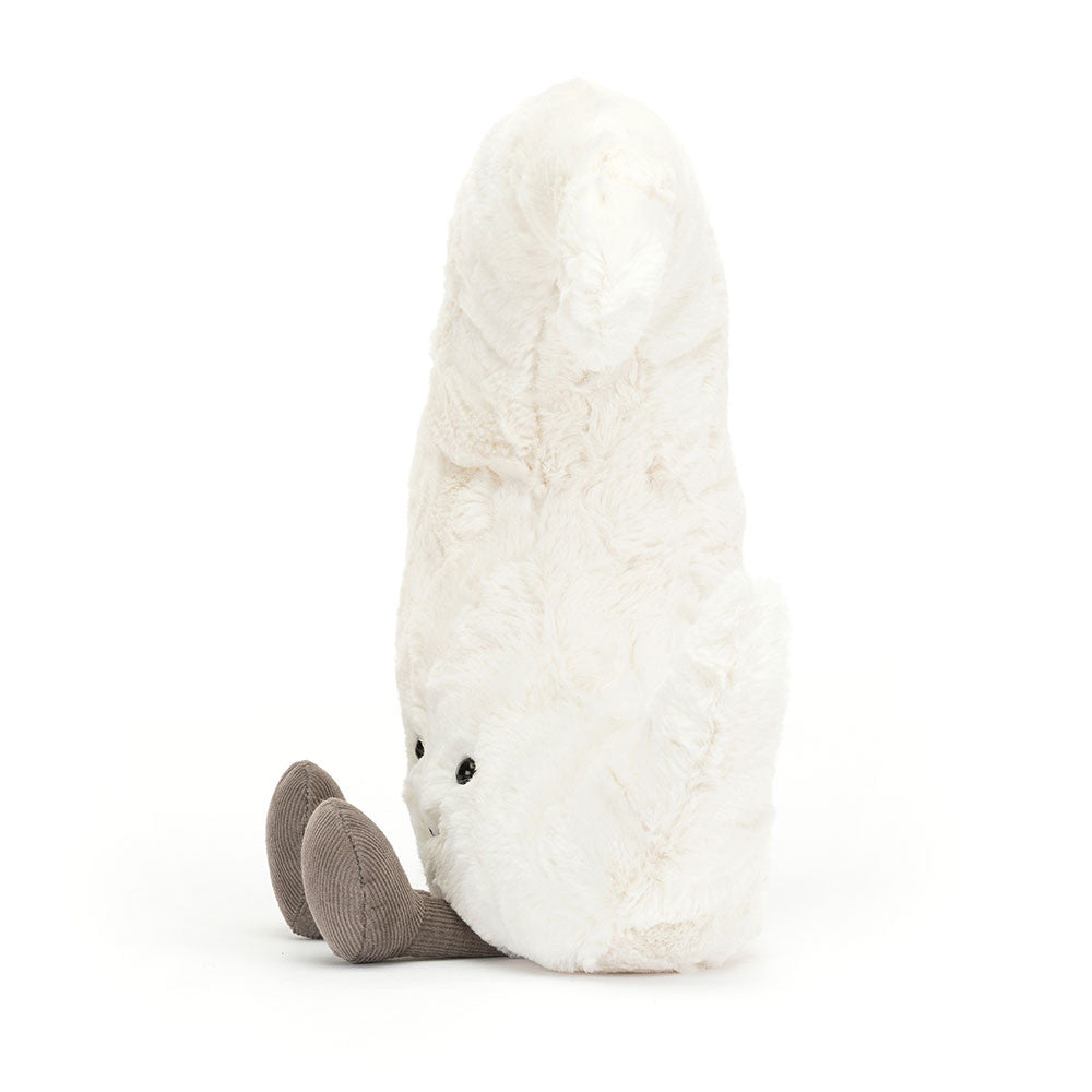 A photo of the side of a white plush crescent moon with a smiling face and grey leggs on a white background