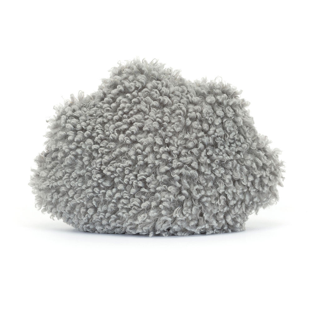 A photo of the back of a grey push toy with black legs, of a storm cloud with a sad expression on a white background
