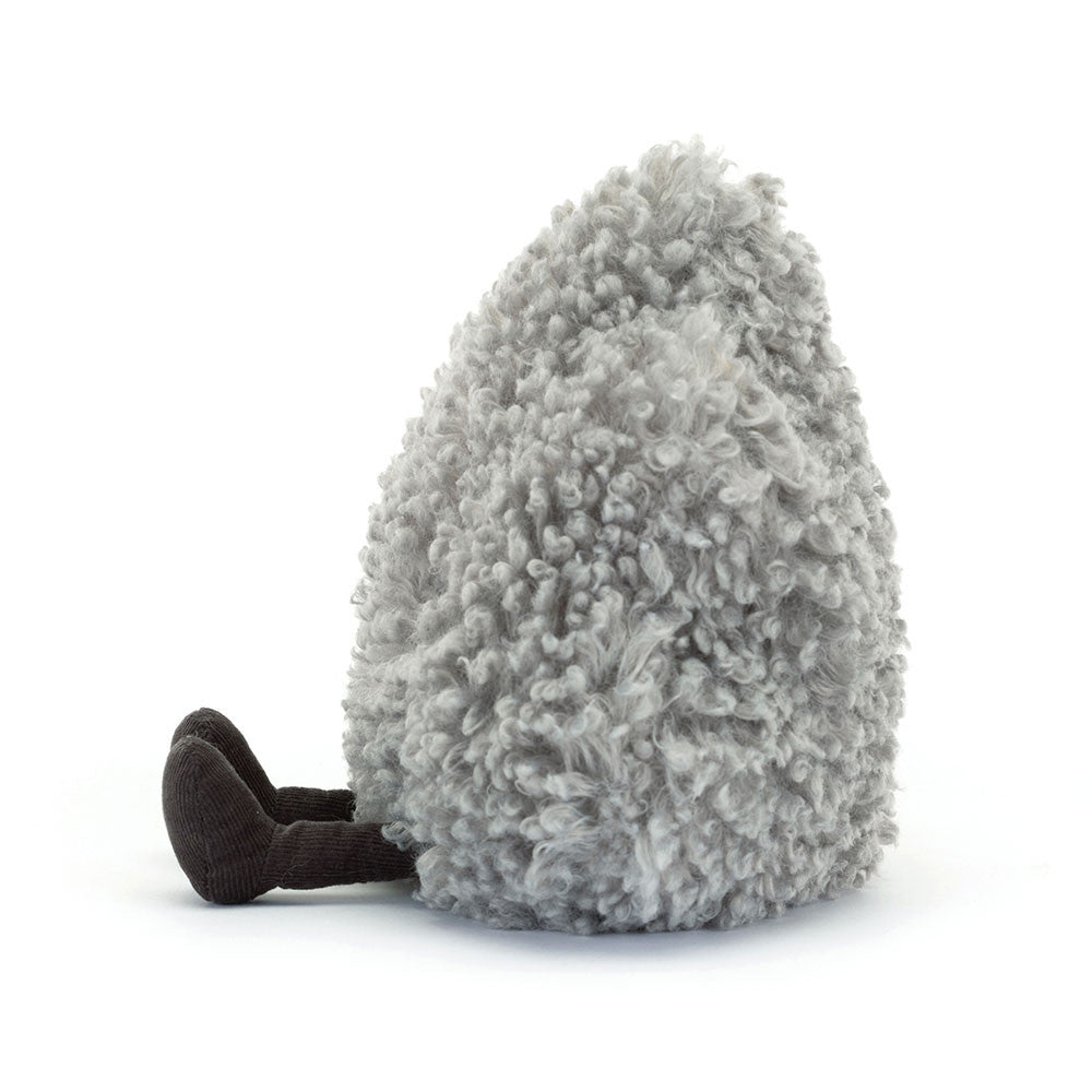 A side photo of a grey push toy with black legs, of a storm cloud with a sad expression on a white background