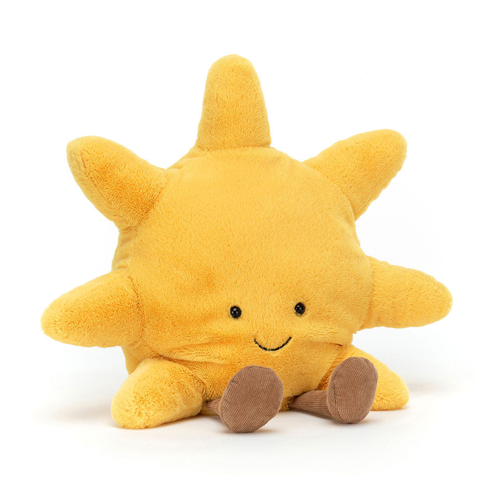 Yellow plush sun toy with a smiling face and brown legs on a white background.