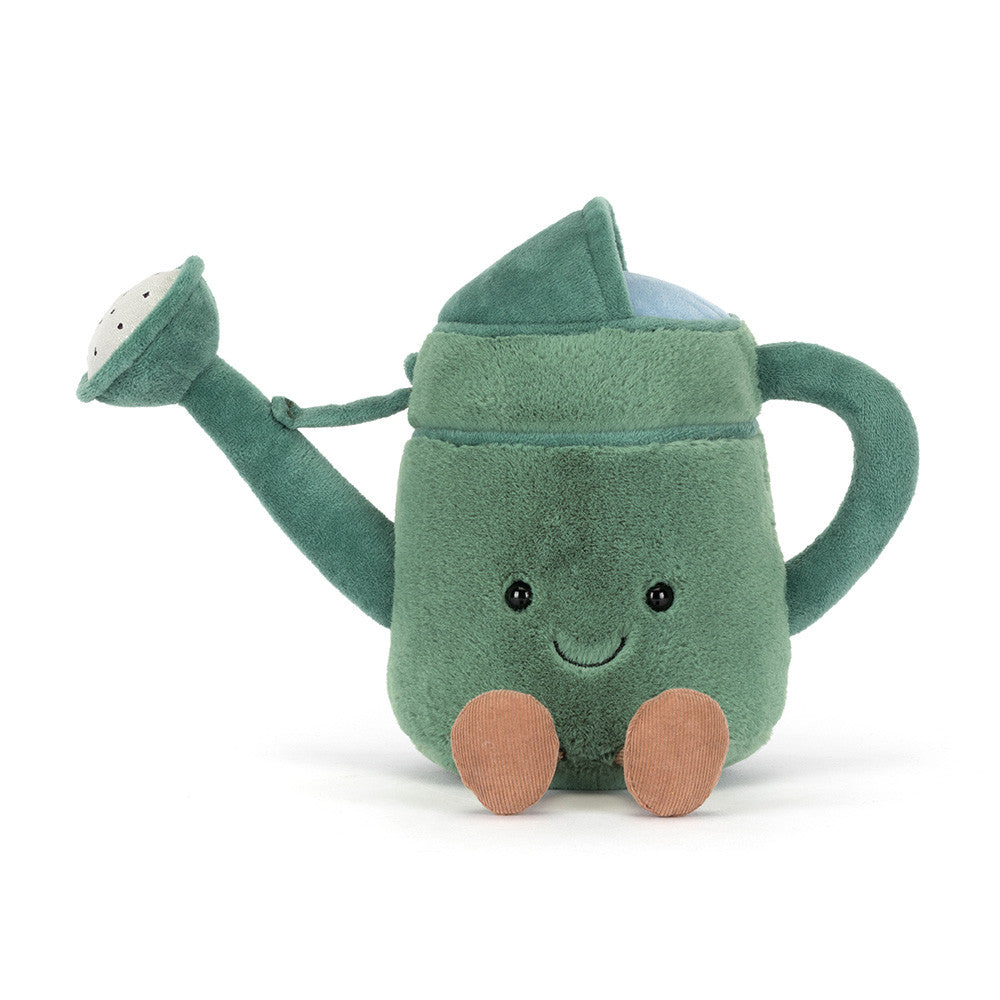 A front facing  photo of a green plush toy watering can with a smiling face and brown legs on a white background.