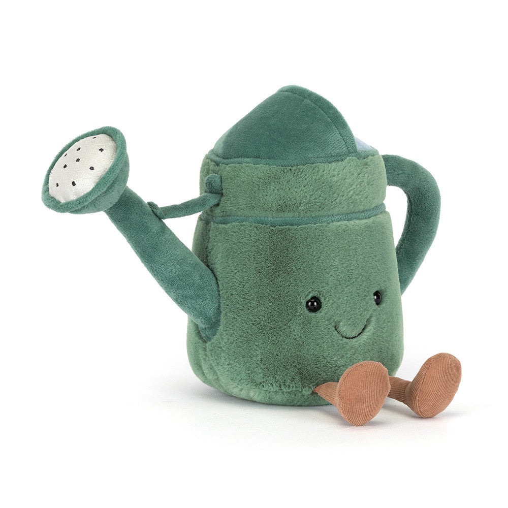 A side angled photo of a green plush toy watering can with a smiling face and brown legs on a white background.