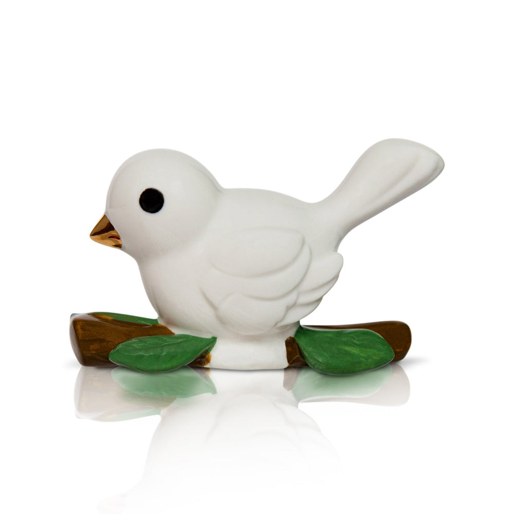 White ceramic bird mini figurine decor with green leaves on a white background