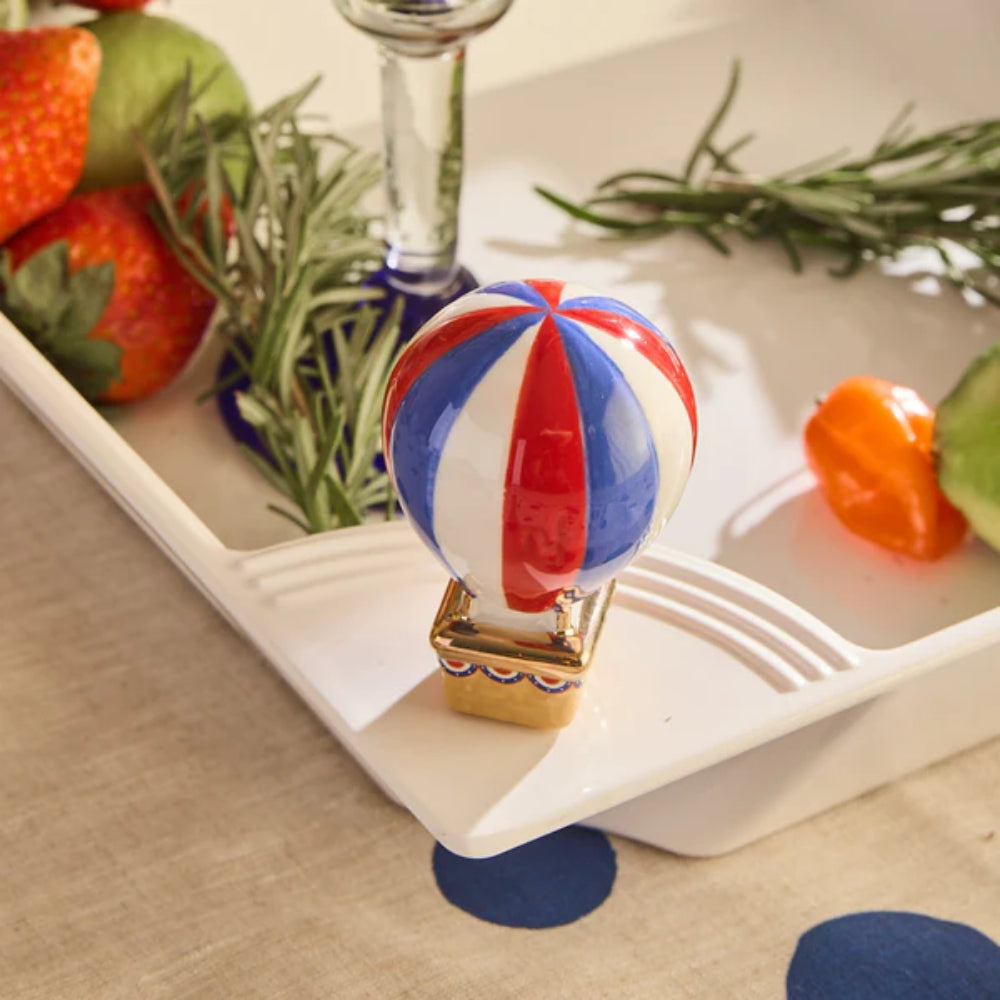 Decorative hot air balloon on a table with strawberries and greenery