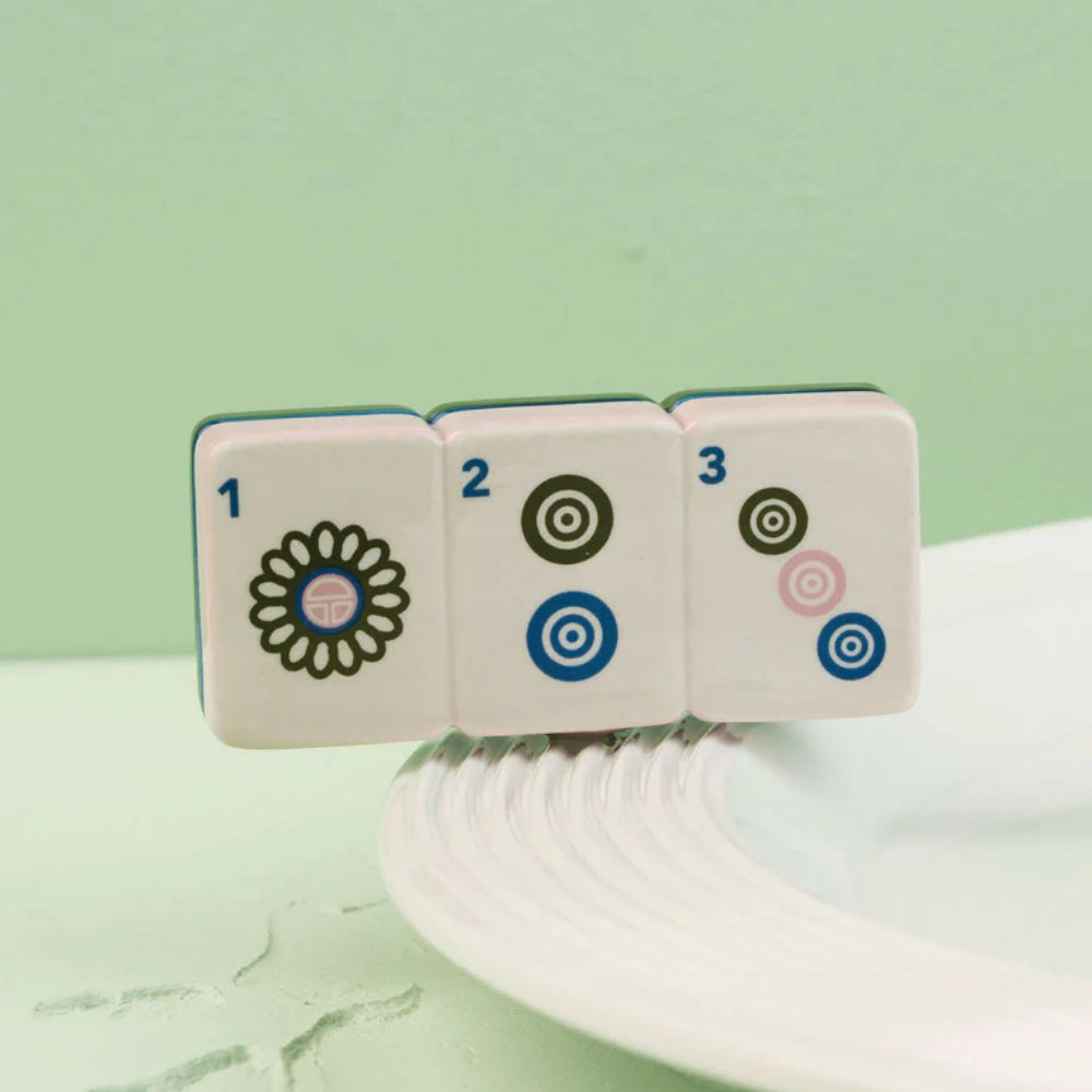 Mahj-ical Mini with numbers and symbols on a light green background.