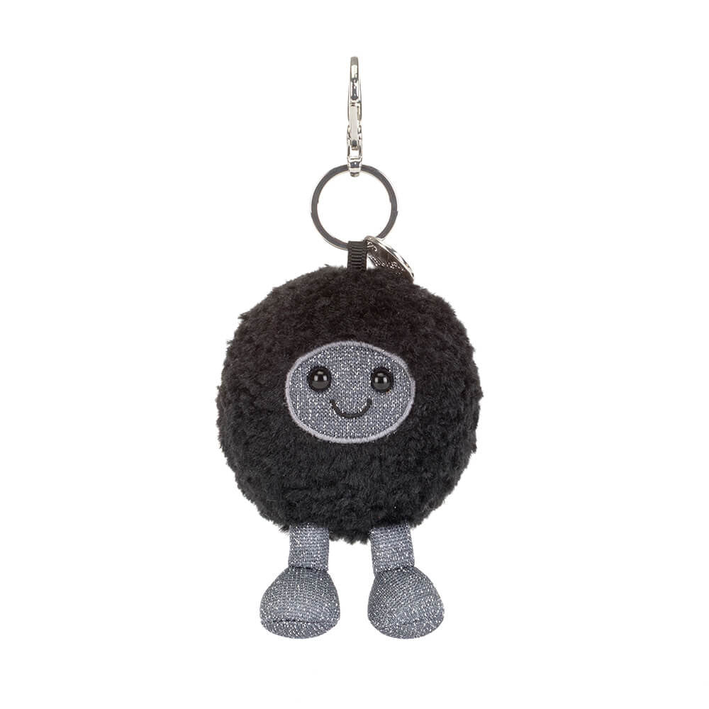 Black hole plush keychain with a grey and black smiling face and grey legs on a white background.