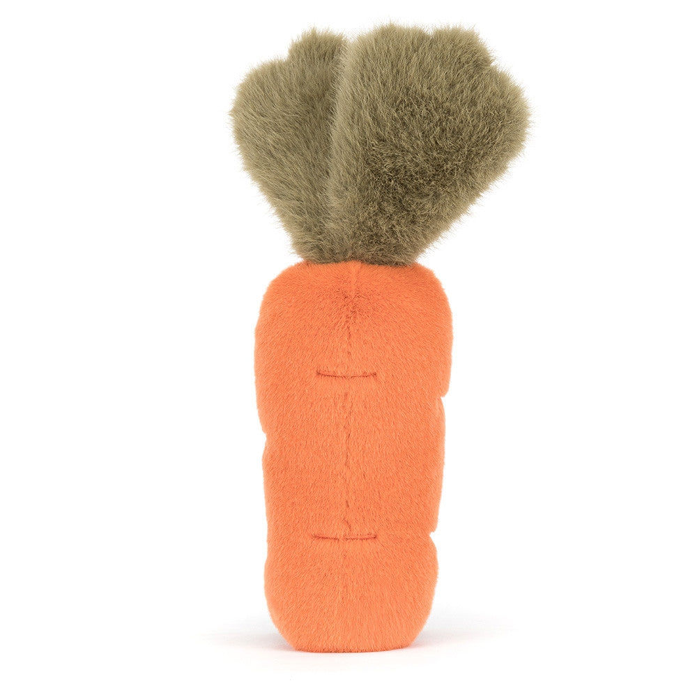 A photo of the back of a orange and green carrot plush toy with a smiling face on and brown legs a white background.