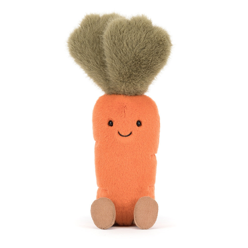 A ftont facing photo of a orange and green carrot plush toy with a smiling face on and brown legs a white background.