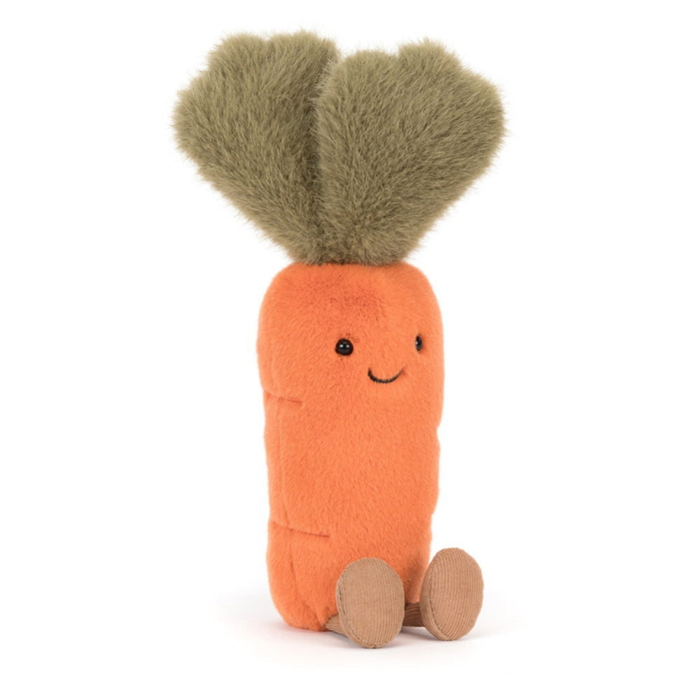 A side angled photo of a orange and green carrot plush toy with a smiling face on and brown legs a white background.