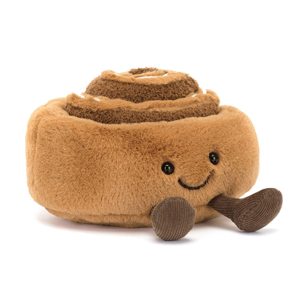 A brown plush toy resembling a cinnamon bun with a happy facial expression, made from brown fur-like material with a cream-colored icing on top.
