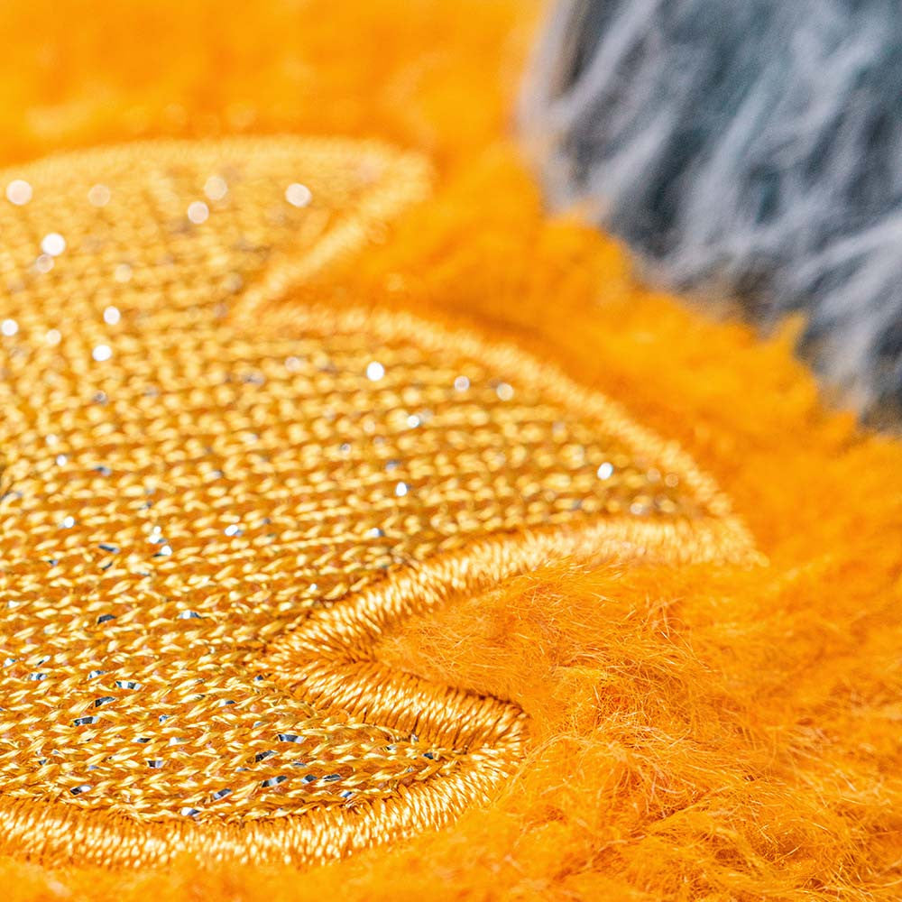 A close up photo of the jellycat amuseables orange space comet showing the orange flame