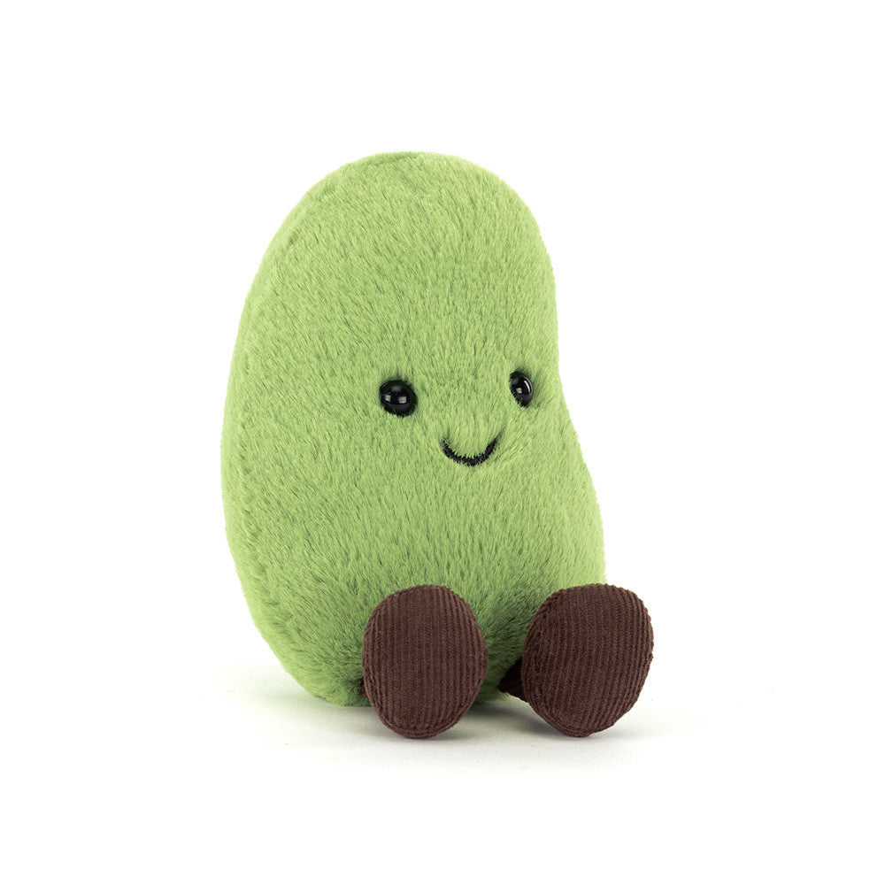 A angled side photo of a green Soyella Bean plush toy with a smiling face and brown legs on a white background.