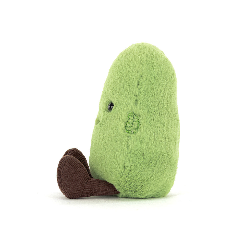 A photo of the side of a green Soyella Bean plush toy with a smiling face and brown legs on a white background.