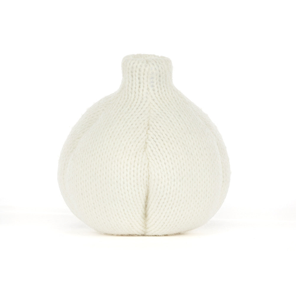 The back of a  knitted garlic character plush toy with a smiling face and olive green feet, photographed against a seamless white background.