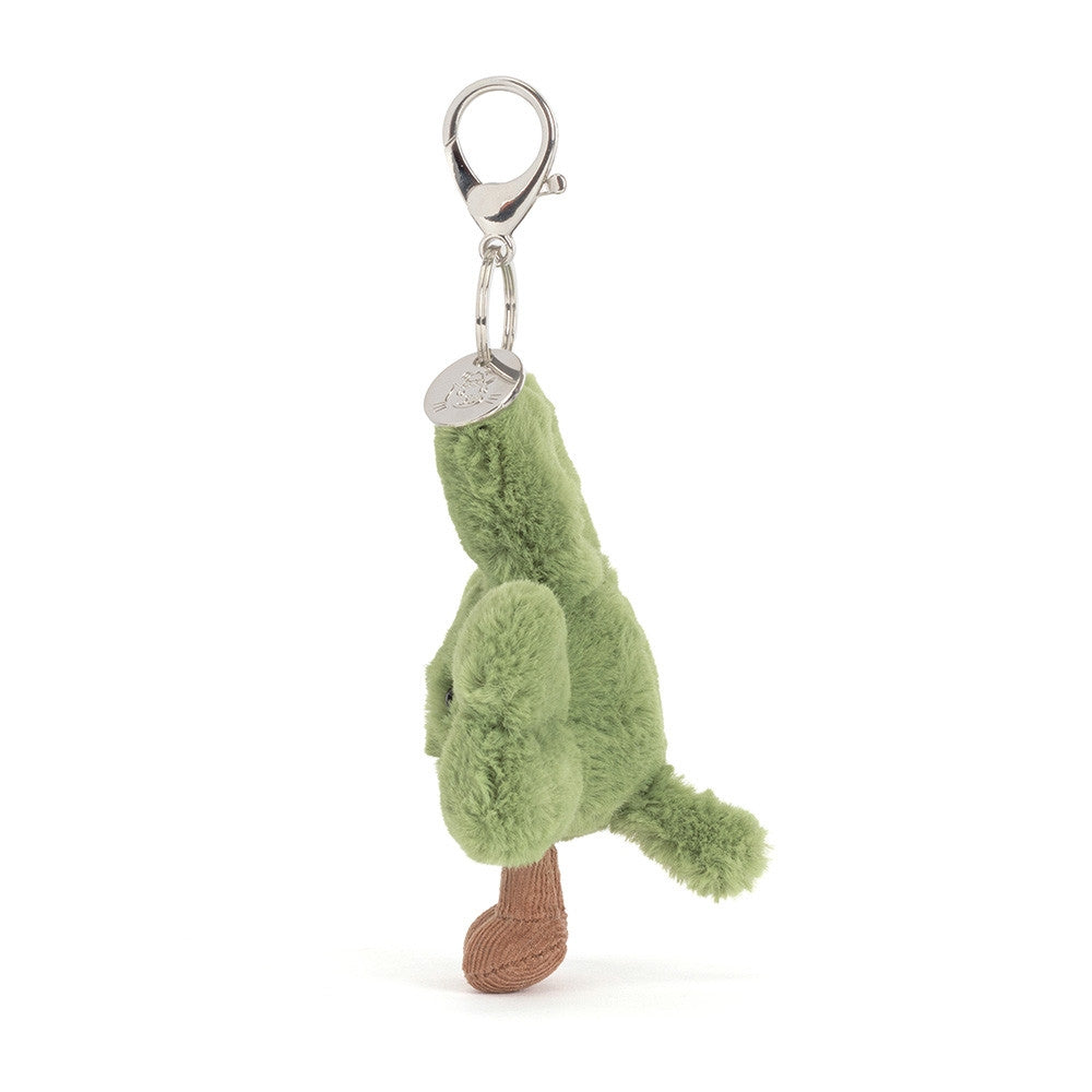 A left side facing photo of a plush green shamrock  keychain with a smiling face on a white background