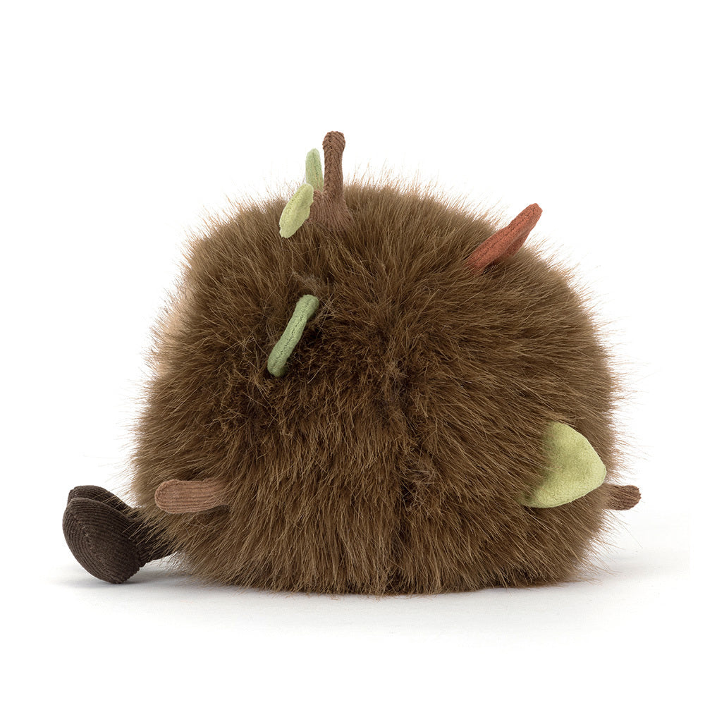A side photo of a Mulshi Woodland Floor plush toy with a smiling face and brown legs on a white background.