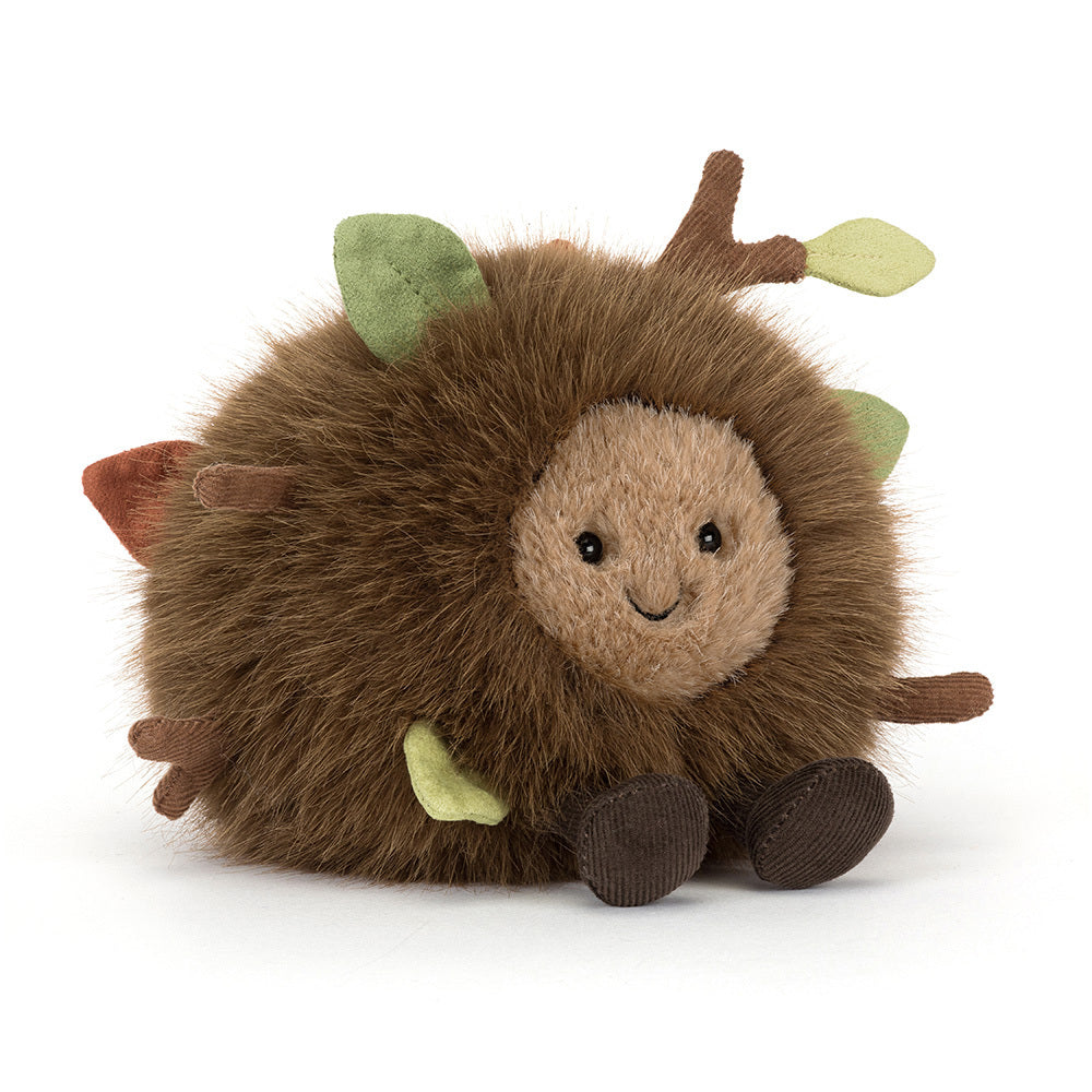 A side angled photo of a Mulshi Woodland Floor plush toy with a smiling face and brown legs on a white background.