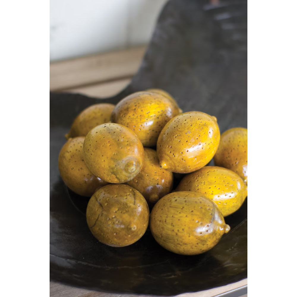 Group of yellow fruits on a dark surface