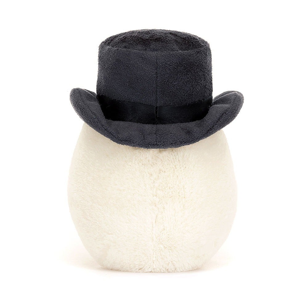 A photo the back of a plush toy representing a boiled egg dressed as a groom with a black hat and  yellow face, sitting upright with cocoa cordy legs.