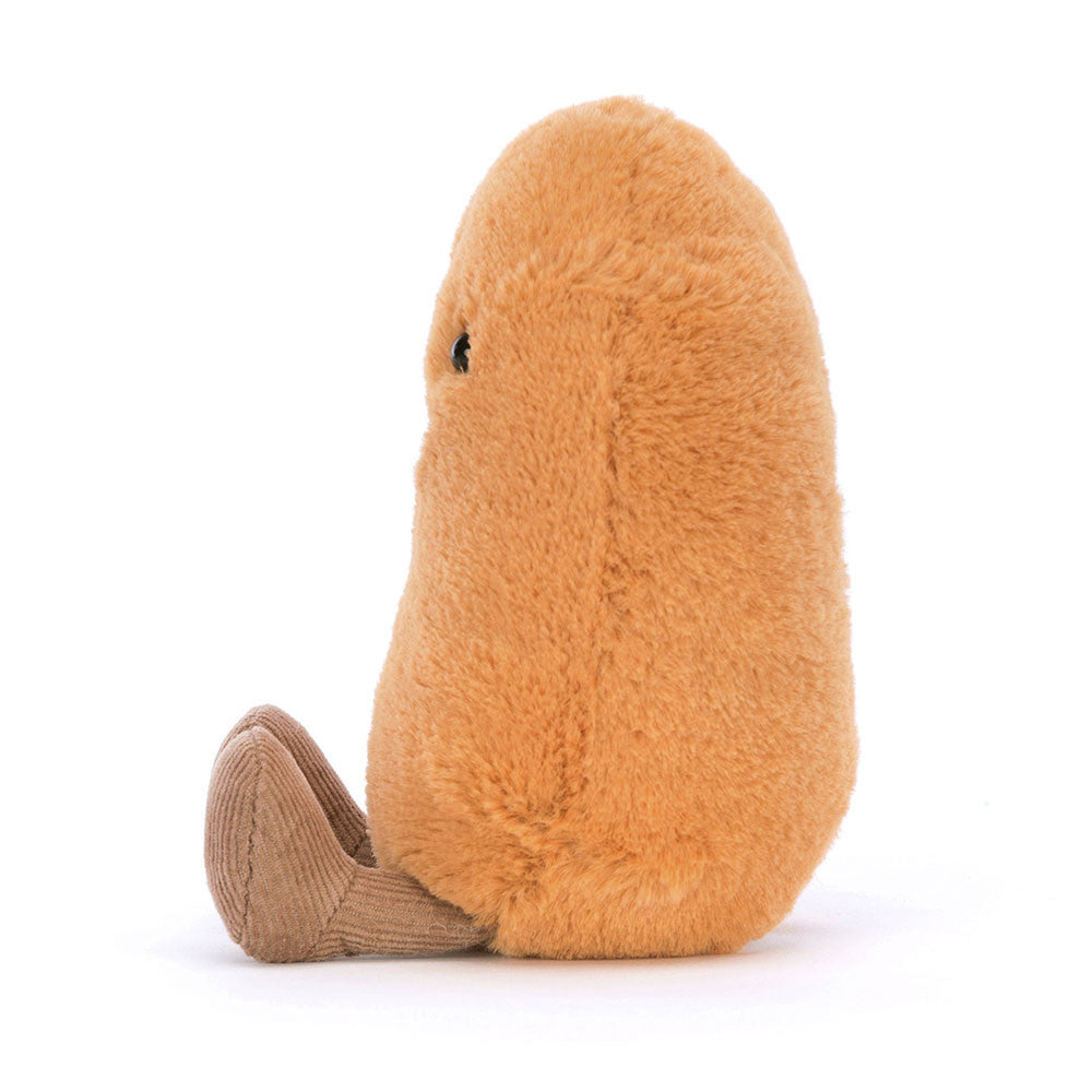 A photo of the side of a plush toy resembling  musterd colored Bean with a smiling face and brown leggs on a white background