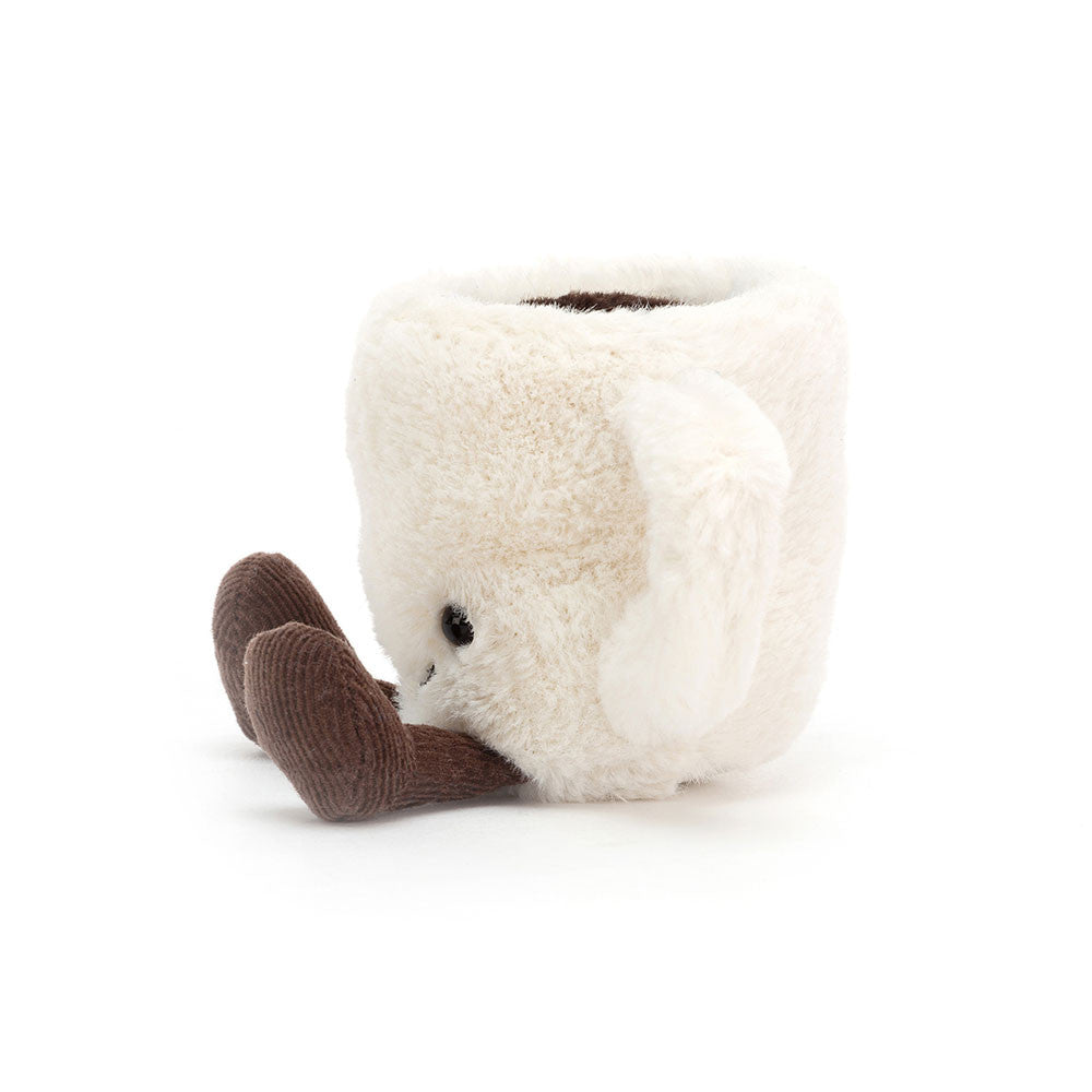 Side photo of a stuffed white Espresso Cup toy with a smiling face and brown legs on a white background.