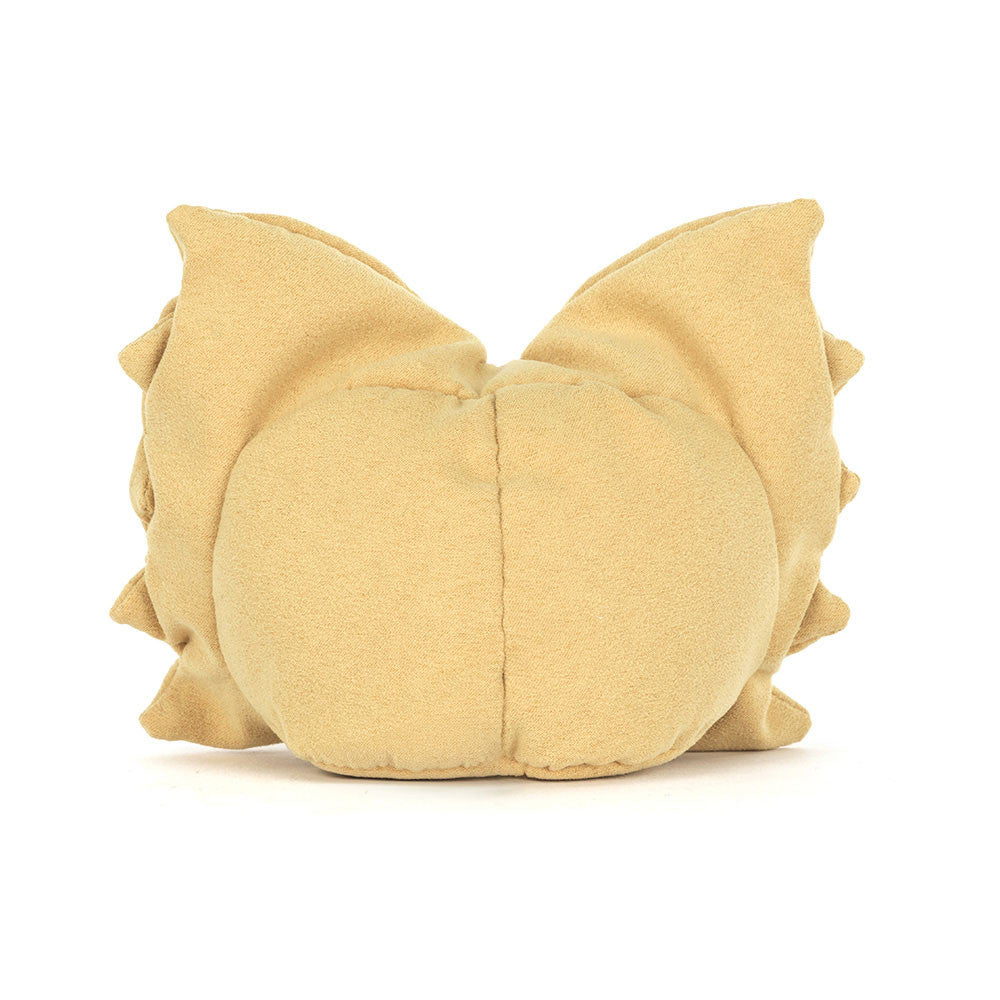 A photo of the back of a plush toy resembling a piece of pasta with golden yellow fur, bright eyes, and brown cord boots.