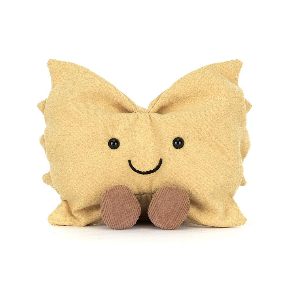 A plush toy resembling a piece of pasta with golden yellow fur, bright eyes, and brown cord boots.
