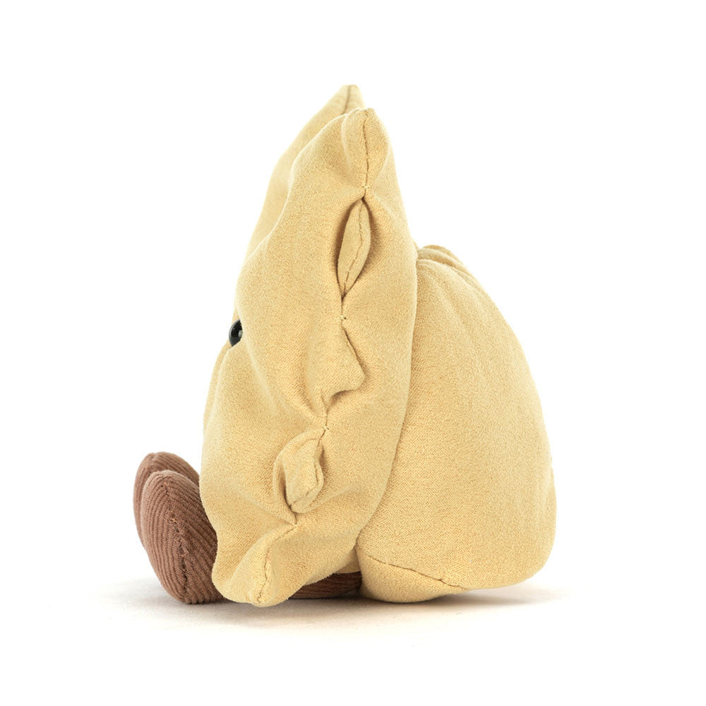 A side photo of a plush toy resembling a piece of pasta with golden yellow fur, bright eyes, and brown cord boots.