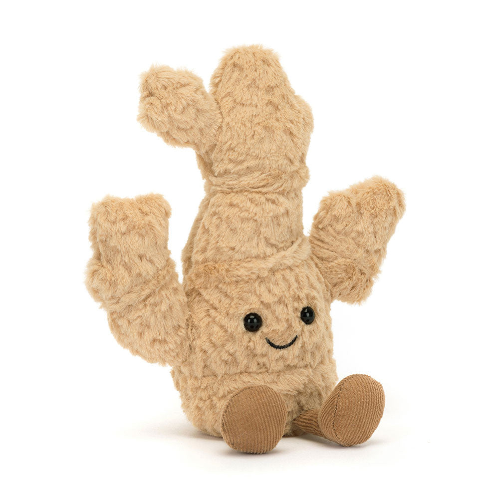 A plush toy resembling a ginger root with a cheerful face, soft golden fur body, and beige corduroy-like texture. It has a pair of toffee-colored boots and is sitting upright.