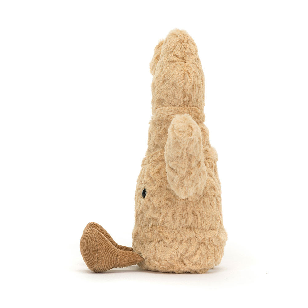 A side photo of a plush toy resembling a ginger root with a cheerful face, soft golden fur body, and beige corduroy-like texture. It has a pair of toffee-colored boots and is sitting upright.