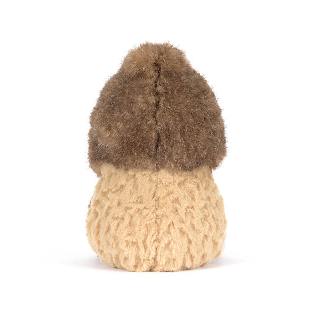 A side photo of the back of a brown Peanut Yeti plush toy with a smiling face on a white background.