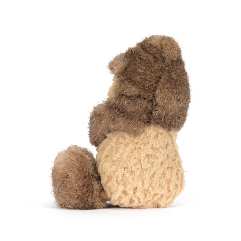 A side photo of a brown Peanut Yeti plush toy with a smiling face on a white background.