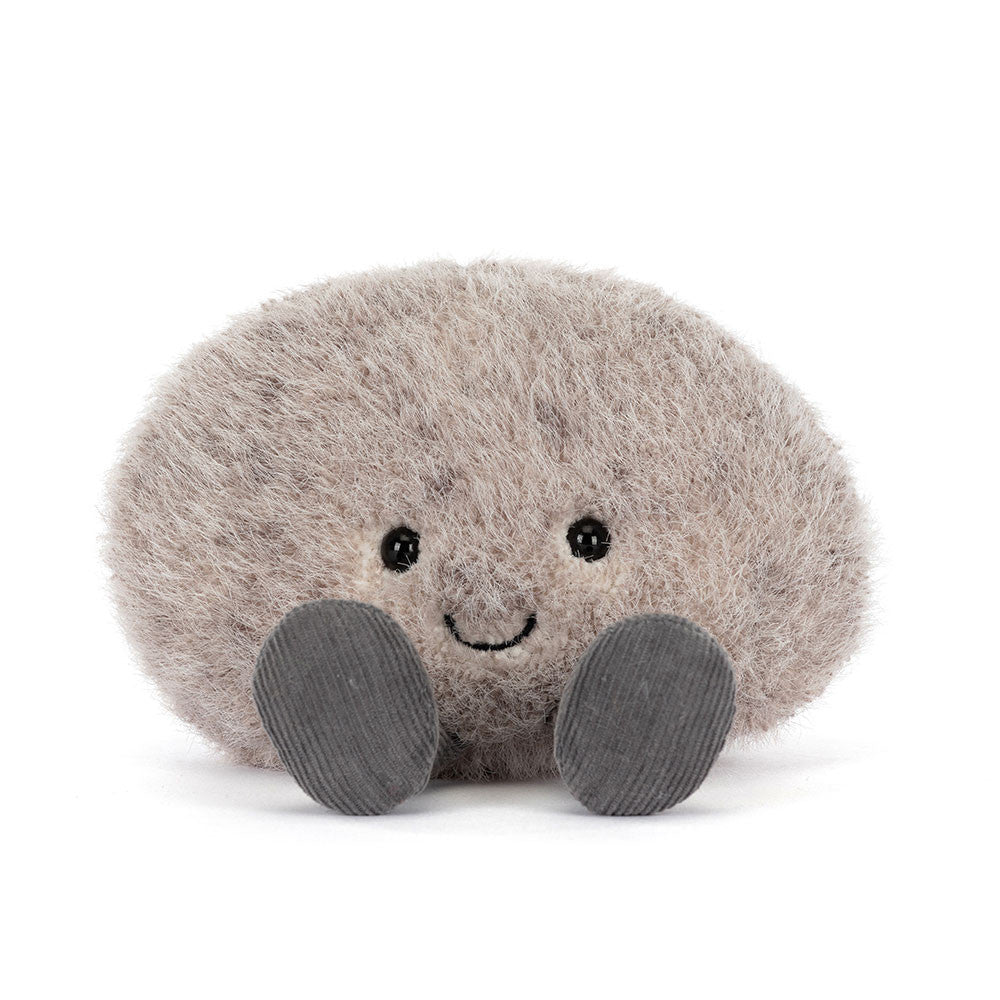 A photo of a grey plush toy resembling a pebble with a smiling face and grey legs on a white backround.