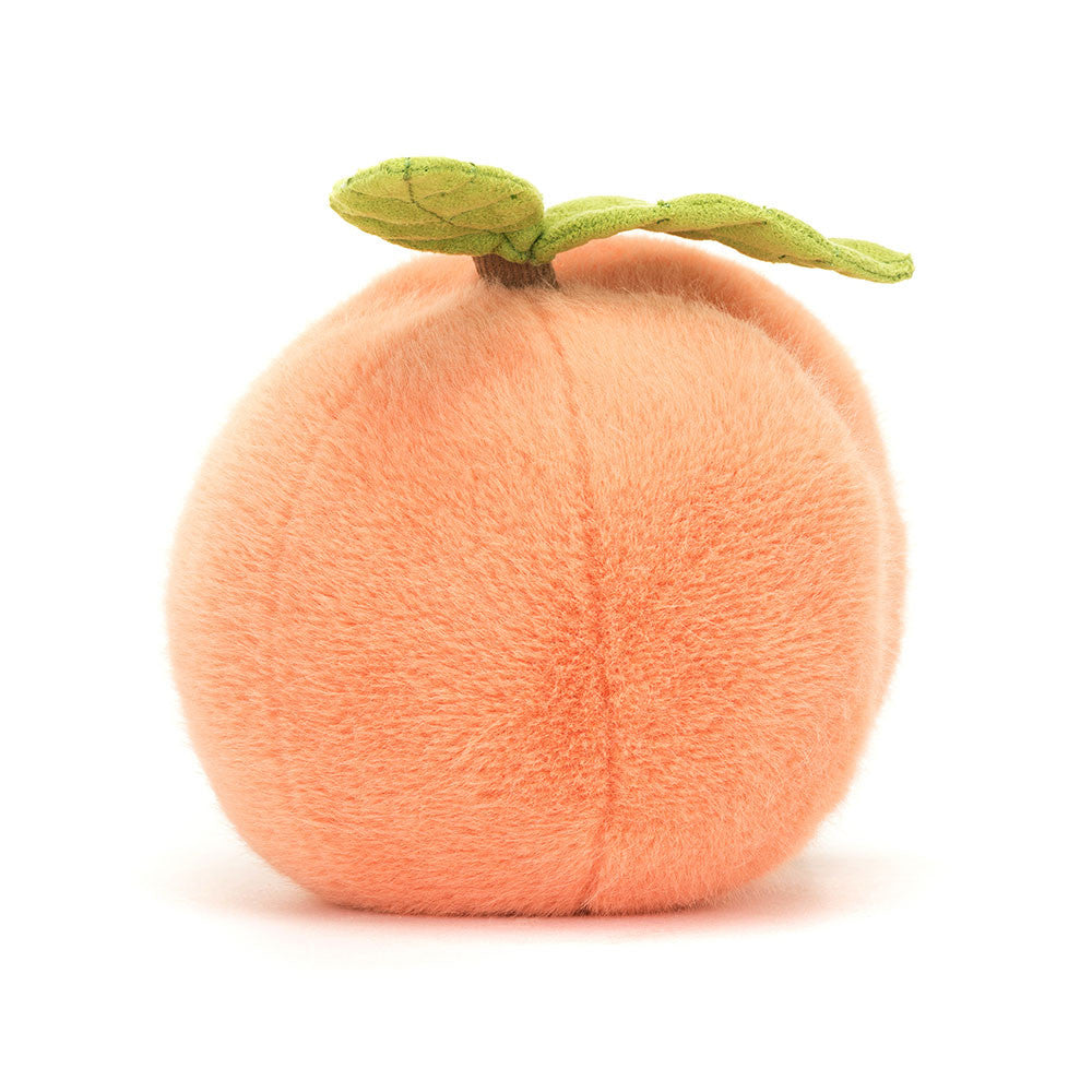 A photo of the back of a peach coloerd plush toy shaped like a peach on a white backround. 