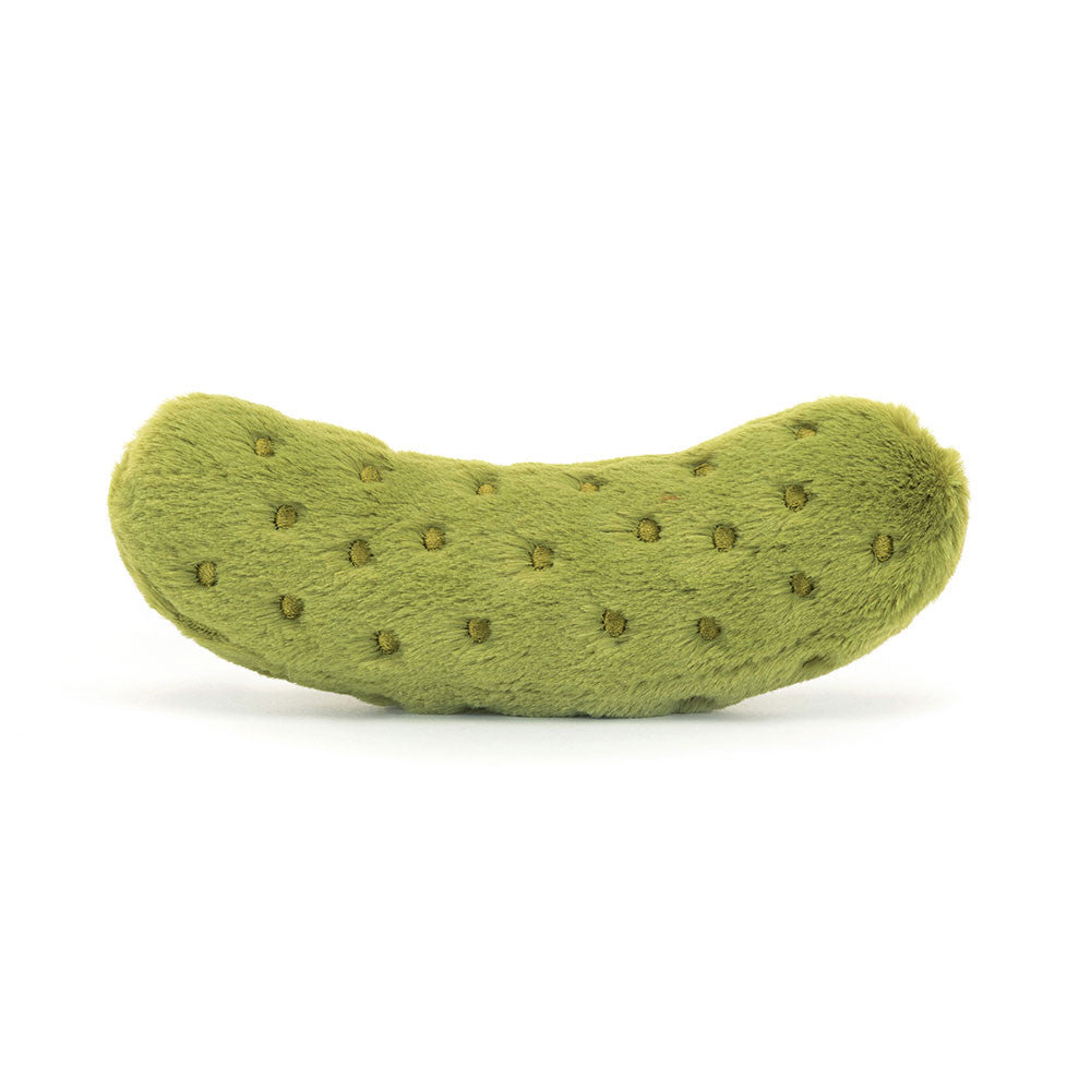 A photo of the back of  a plush toy resembling a green pickle with embroidered freckles, nutty cord boots, and a smiling face.