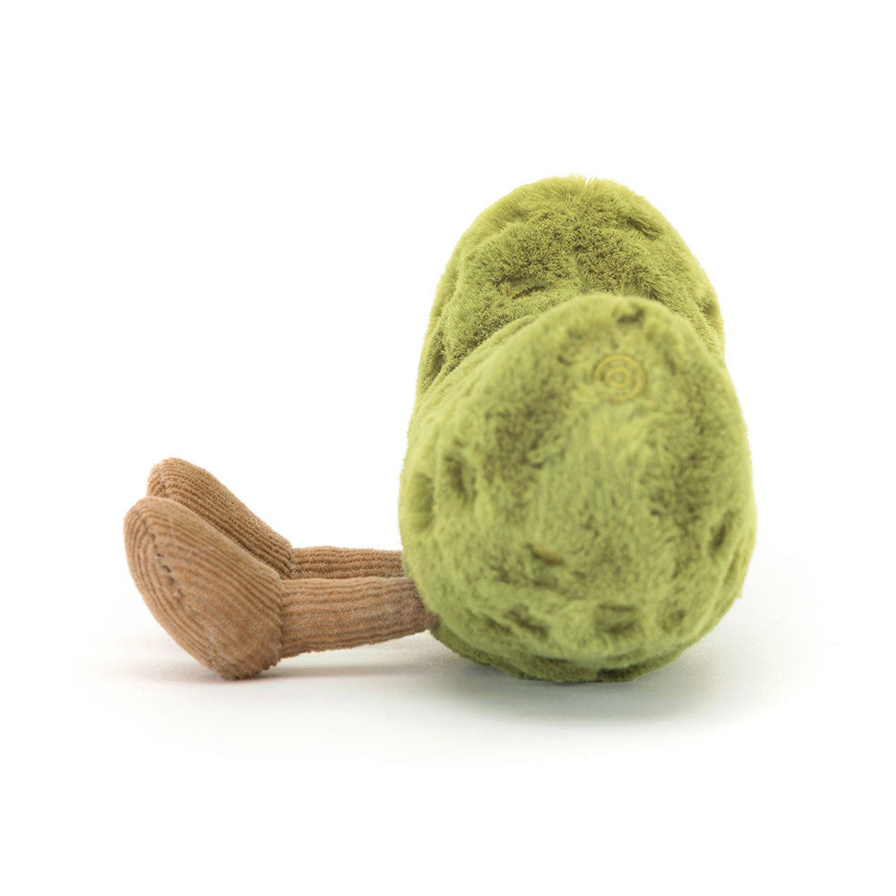 A side photo of a plush toy resembling a green pickle with embroidered freckles, nutty cord boots, and a smiling face.