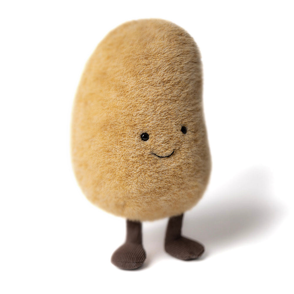 Plush toy shaped like a potato with a smiling face and brown legs and feet standing on a white background.