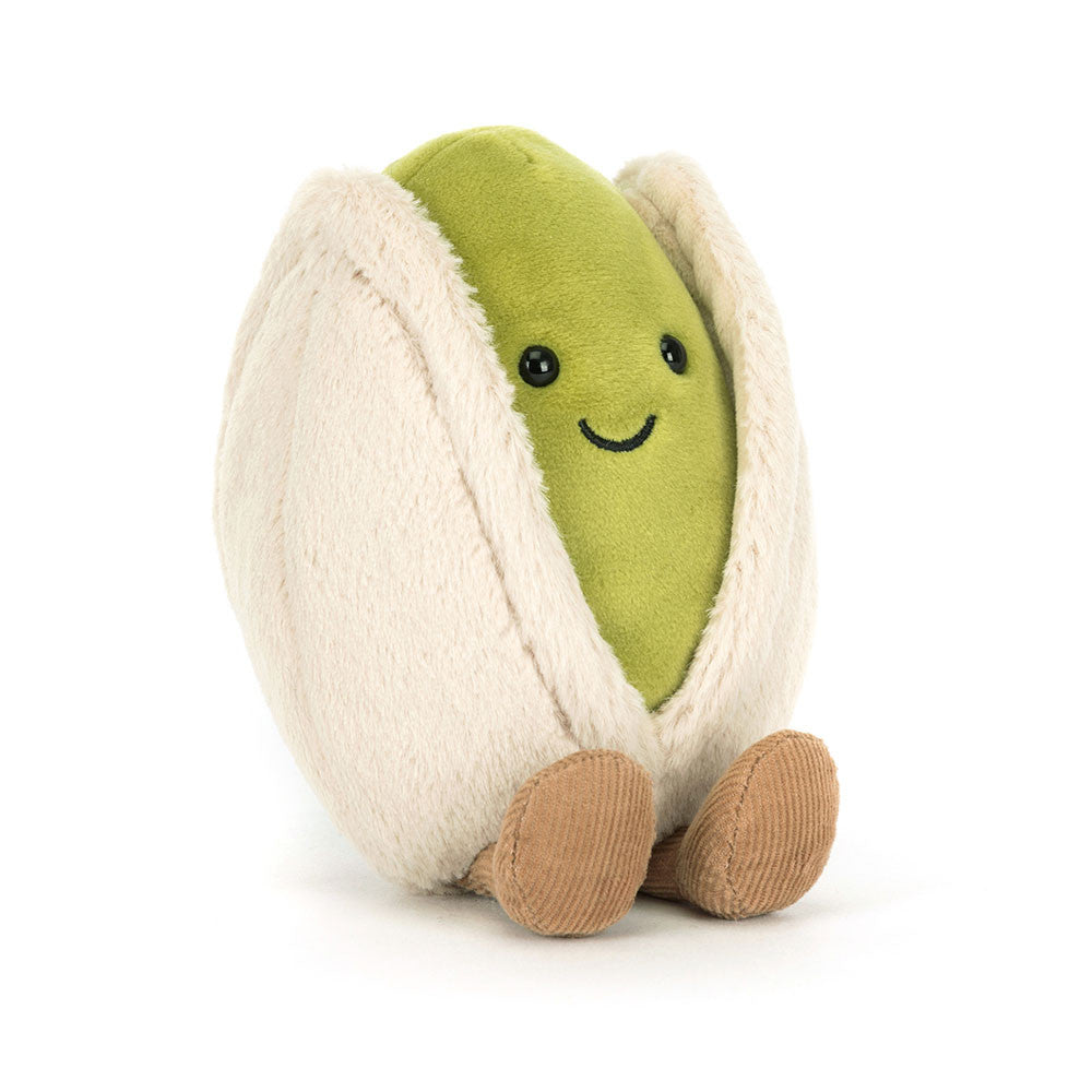 A angled photo of a green and white plush toy shaped like a green pea in a pod with a smiling face on a white background.