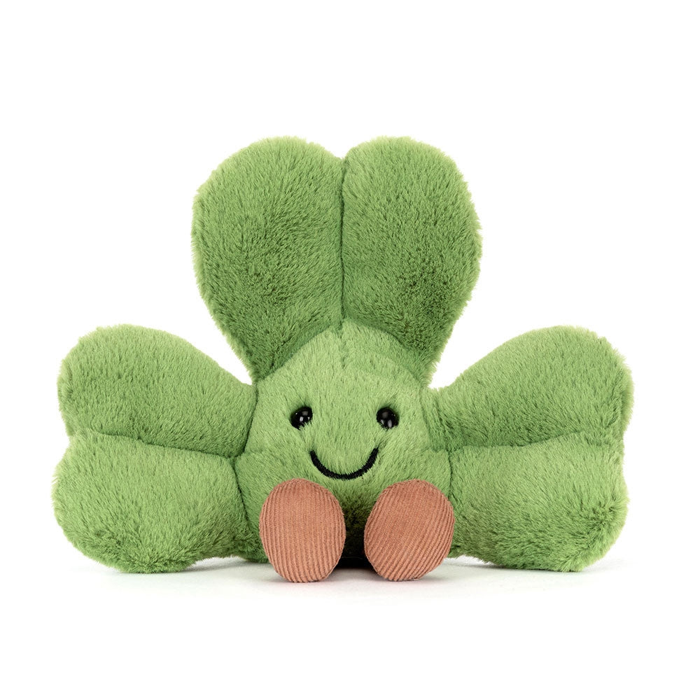 A front facing photo of green plush shamrock toy with a happy face on a white background