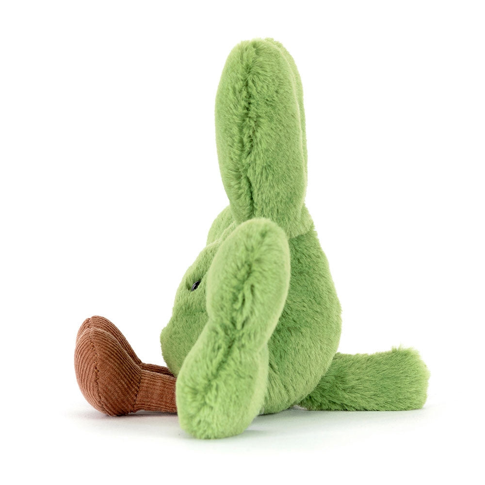 A left side facing photo of green plush shamrock toy with a happy face on a white background