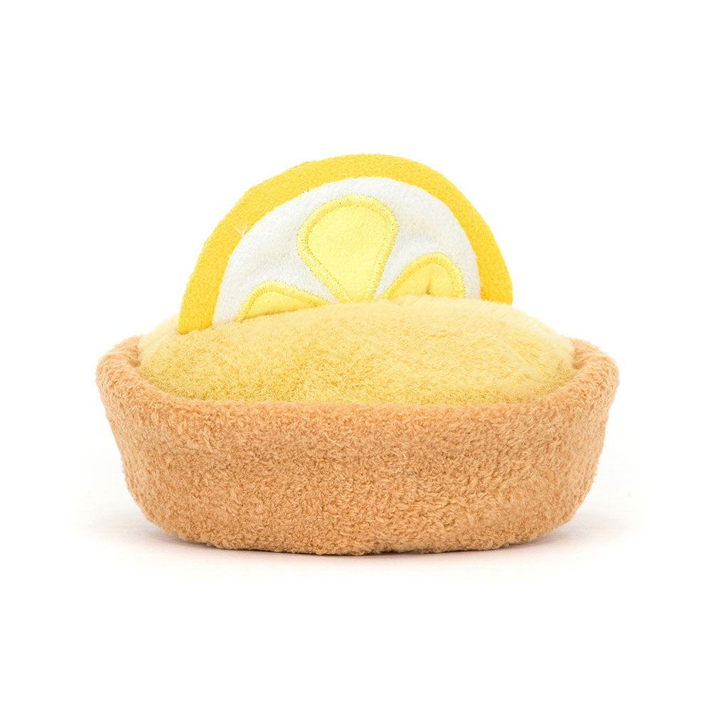 The back of a plush toy resembling a lemon with a smiling face on a white background.