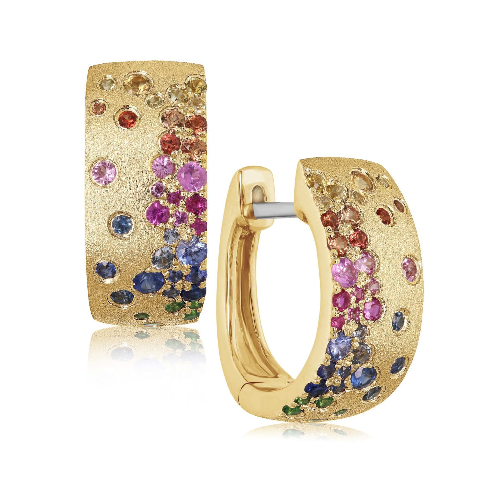 Brushed gold hoop earrings with flush set multicolored sapphires and tsavorite on a white background