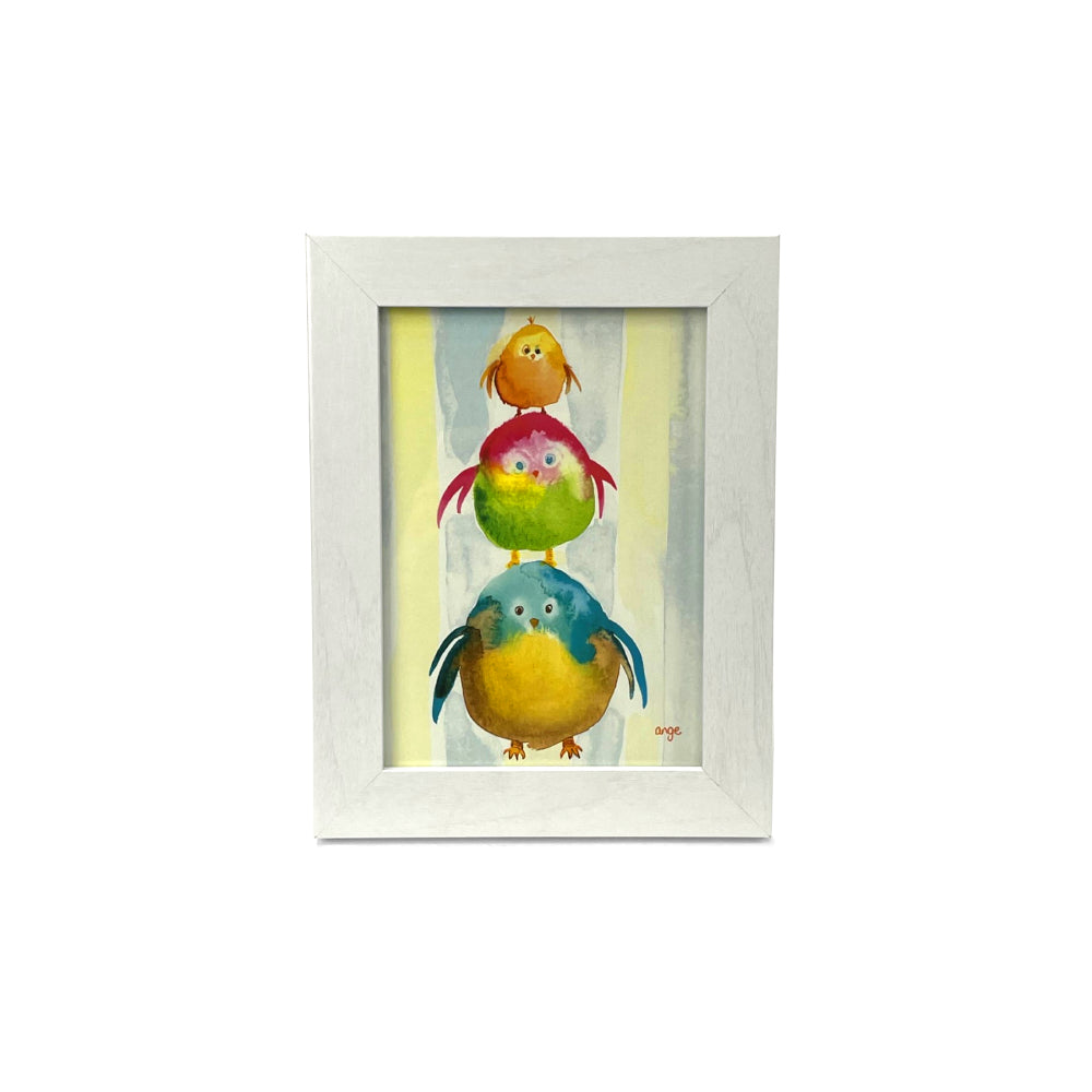White framed artwork of three colorful birds stacked on top of each other against a light background.
